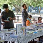 People busy in selecting and purchasing old books from a stall at the premises of Frere Hall building