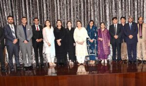 IAC Chancellor Muhammad Faisal Janjua presents a shawl to the Prime Minister's Special Assistant on Human Rights Ms. Mashaal Hussain Malik on the occasion of a seminar on women's empowerment at the Institute of Art and Culture