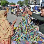 A vendor displaying the stationary item (Colorful pencils) to attract the customers outside the Yakki Gate