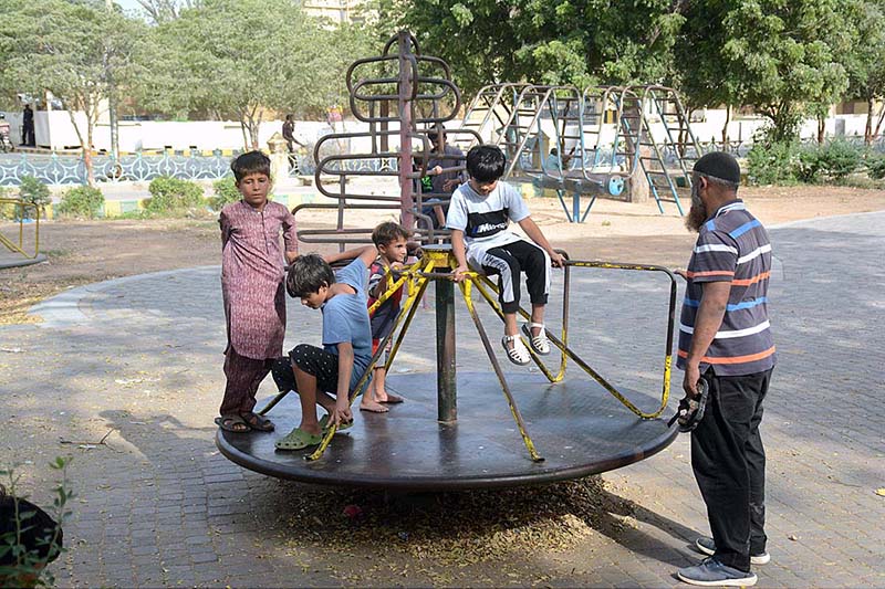 Children enjoying on marry-go-round in the premises of Frere Hall building