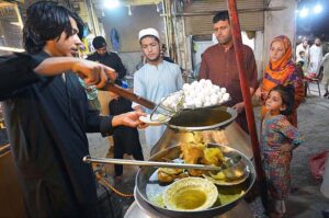 A vendor selling boiled eggs and traditional Yakhni at Hashtnagri area.