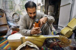 Workers busy in making traditional musical instrument (Rabab) at his workplace in the Dabgari area