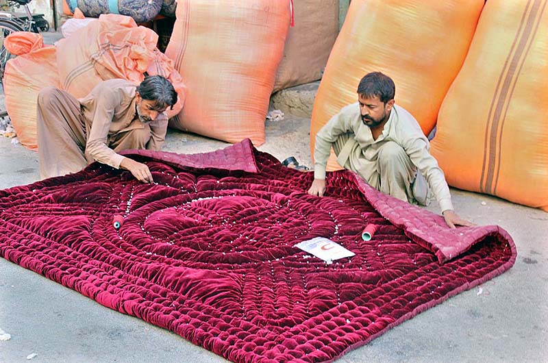 Vendors busy sewing and manually making woven quilt at his work place for upcoming winter as the demand for woolies and quilts