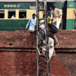 Passengers alighting from electricity pole which is most dangerous mode to come out from railway track, after leaving slow moving train only few yards away railway station from the site at Do Moria Bridge, may cause any mishap and needs attention of the concern authorities