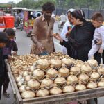 Women and children are busy shopping for golden Golak (money boxes) following the traditional method of collecting money from a cart near Bibi Pak Daman