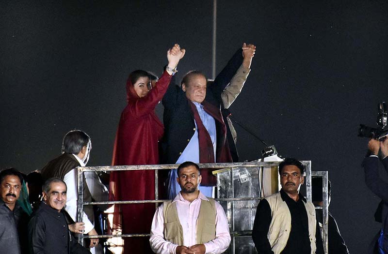 PML-N Supremo and former Prime Minister Nawaz Sharif waving to the crowd before his first address to a public rally at Minar-e-Pakistan after he returned to country after four years of self-exile in London