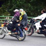 Woman motorcyclist on the way towards her destination