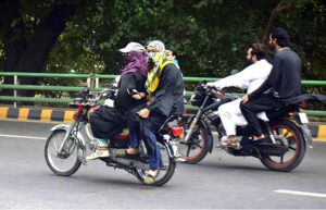 Woman motorcyclist on the way towards her destination