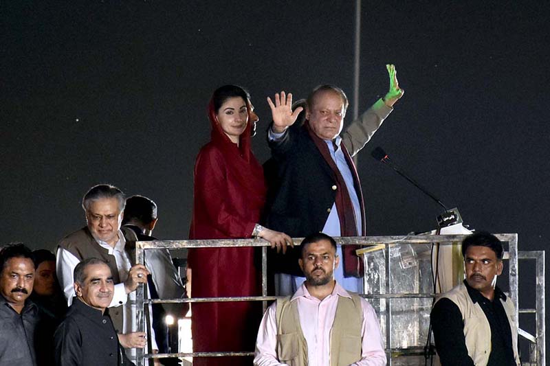 PML-N Supremo and former Prime Minister Nawaz Sharif waving to the crowd before his first address to a public rally at Minar-e-Pakistan after he returned to country after four years of self-exile in London