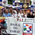 Activists of civil society holding play cards during a protest demonstration to show solidarity with the people of Palestine and take part in an anti-Israel demonstration outside the Press club