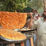 A halwai is preparing Katlama at, Miani Sahib Graveyard.