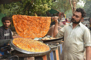 A halwai is preparing Katlama at, Miani Sahib Graveyard.