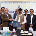 Secretary Forest Gilgit-Baltistan Zafar Waqar Taj and VC Karakoram International University Attaullah Shah exchanging documents after signing MOU between KIU and Forest Department at KIU.