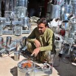 A vendor demonstrates igniting of locally made heater. This newly launched heater is low in cost and could be used with the used oil.