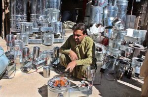 A vendor demonstrates igniting of locally made heater. This newly launched heater is low in cost and could be used with the used oil.