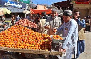 A vendor displaying persimmon to attract the customer. 