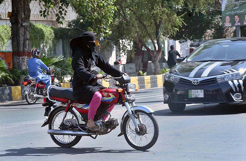 Woman riding motorcycle on the way towards her destination in the City