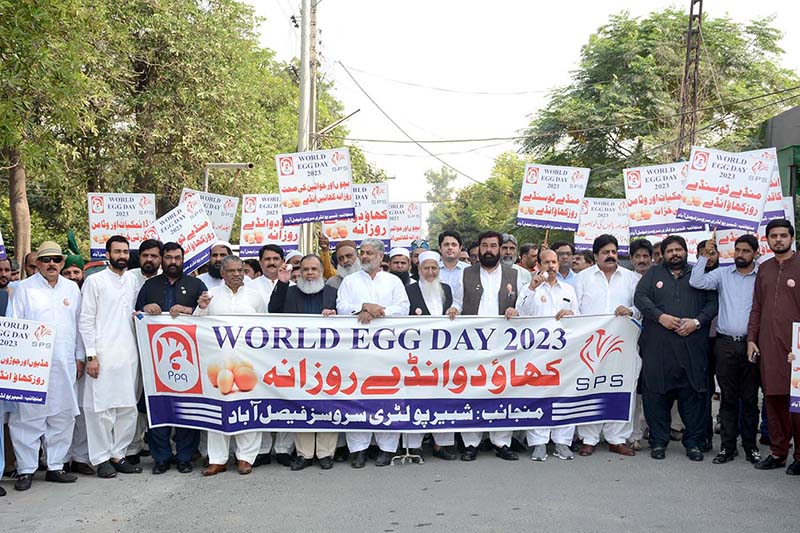People from different poultry organizations are participating in a walk on the eve of World Egg Day organized by Shabbir Poultry Services