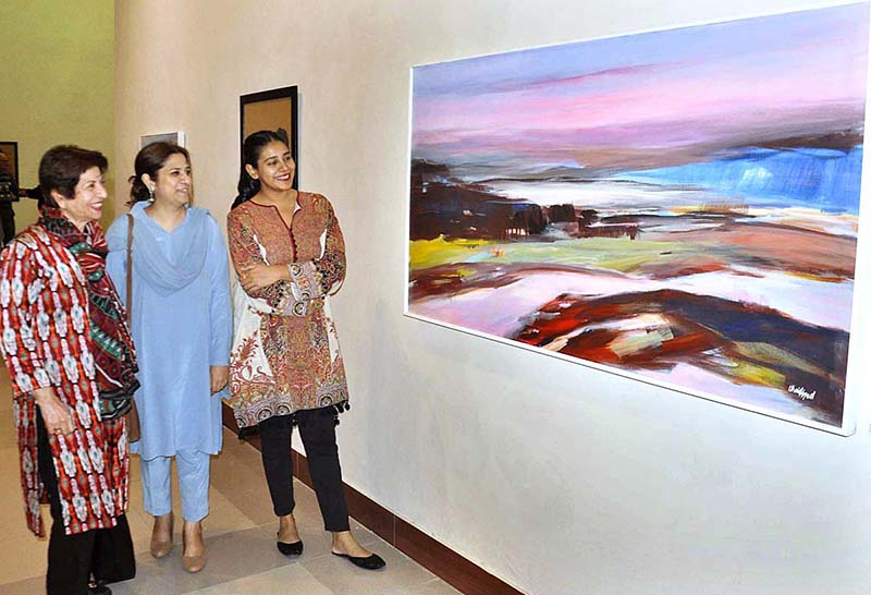 Visitors keenly viewing art work displayed during an exhibition PNCA & Nomad gallery present Safar-Journey of the Mavericks three person curetted by Nageen Hyat at PNCA