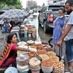 Women vendors sell dry fruits for livelihood at their setup along boundary wall of Empress Market