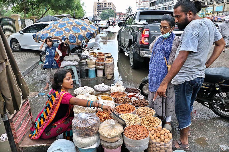 Women vendors sell dry fruits for livelihood at their setup along boundary wall of Empress Market