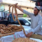 A vendor displaying figs to attract customer which demands increased in winter season at Masjid Road