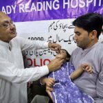 Chairman of Board of Governors Lady Reading Hospital Muhammad Zubair Khan administering polio drops to a child during a Polio Vaccination Campaign at Lady Reading Government Hospital