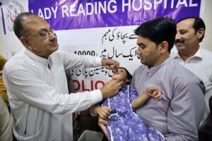 Chairman of Board of Governors Lady Reading Hospital Muhammad Zubair Khan administering polio drops to a child during a Polio Vaccination Campaign at Lady Reading Government Hospital