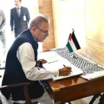 President Dr Arif Alvi recording his remarks in the condolence book during his solidarity visit to the Palestinian embassy