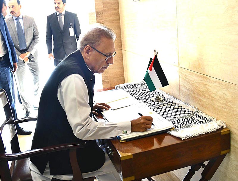 President Dr Arif Alvi recording his remarks in the condolence book during his solidarity visit to the Palestinian embassy