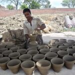 Craftsmen preparing clay made pots at his workplace