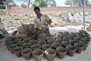 Craftsmen preparing clay made pots at his workplace