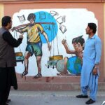 Young people watching beautiful sight of paint on wall of Deputy Commissioner Office.