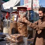 A vendor Display and arrange dry fruits at his road side setup