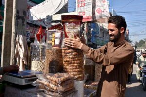 A vendor Display and arrange dry fruits at his road side setup
