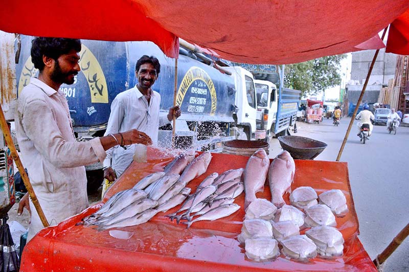 A man selling fish at a roadside stall