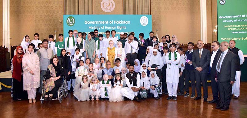 President Dr Arif Alvi and Begum Samina Alvi in a group photo with visually impaired persons at an event in connection with White Cane Safety Day, held at Aiwan-e-Sadr