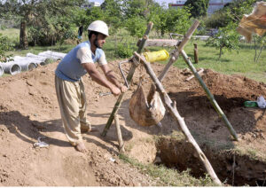 Laborers are excavating the ground to install new RCC pipe lines at the F-6 Sector.