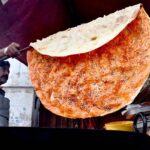 A vendor preparing the traditional food item (Katlama) to attract the customers on the roadside setup at Shadman in the Provincial Capita