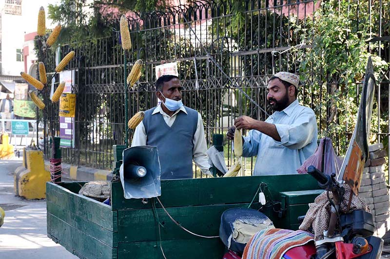 A vendor selling out corn sticks at his road side set up