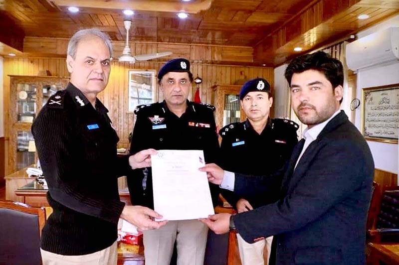IGP Gilgit-Baltistan Afzal Mehmood Butt giving away certificate to Tariq Ali and Hassan Abbas after completing the training of computer forensic and latent fingerprint from the Punjab Forensic Science Agency (PFSA)