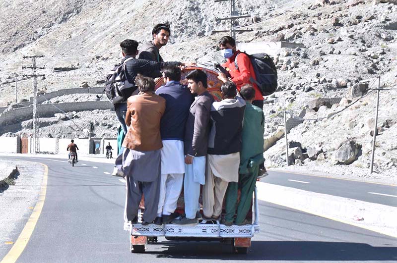 People hanging on passenger van in risky way may cause any mishap, needs the attention of concerned authorities.