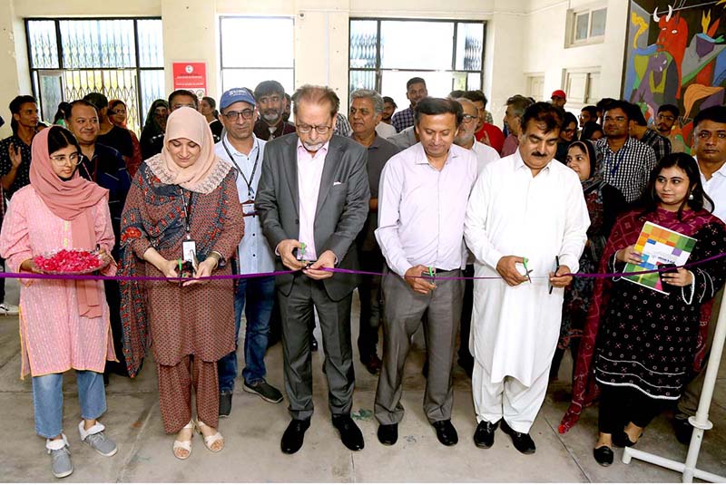 President Arts Council of Karachi Ahmed Shah cutting the ribbon to inaugurate painting and arts work exhibition at Art and Design University of Sindh Jamshoro
