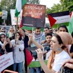 Palestinian students and civil society workers are holding placards and protesting outside the press club to express solidarity with the Palestinian people