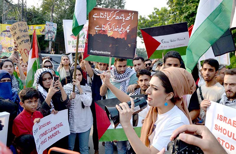 Palestinian students and civil society workers are holding placards and protesting outside the press club to express solidarity with the Palestinian people