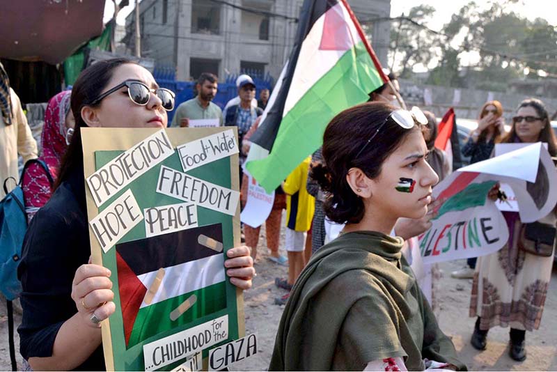 Palestinian students and civil society workers are holding placards and protesting outside the press club to express solidarity with the Palestinian people