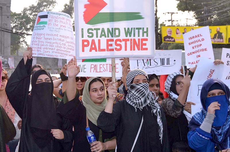 Palestinian students and civil society workers are holding placards and protesting outside the press club to express solidarity with the Palestinian people