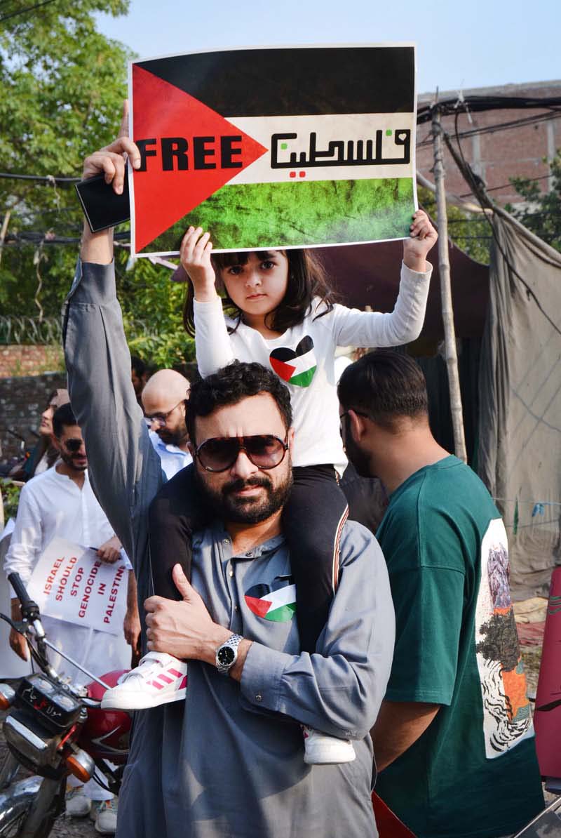 Palestinian students and civil society workers are holding placards and protesting outside the press club to express solidarity with the Palestinian people