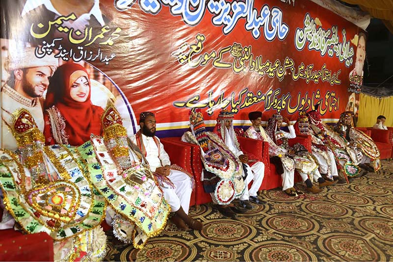 A large number of grooms sitting on stage during collective marriage organized by Jailani Welfare Organization at Bagh-e-Mustafa Ground.