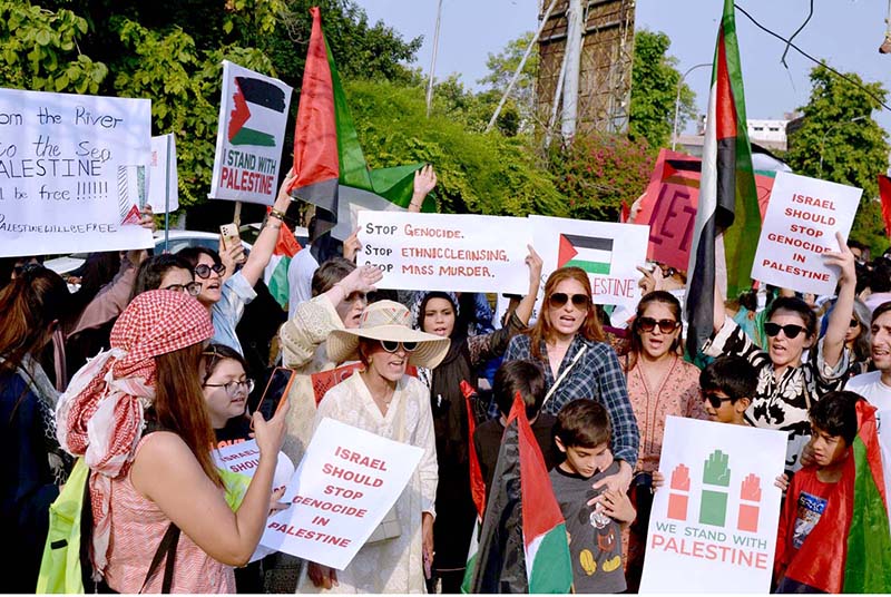 Palestinian students and civil society workers are holding placards and protesting outside the press club to express solidarity with the Palestinian people